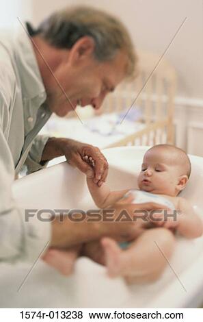 Side profile of a grandfather playing with his grandson View Large Photo Image Stock Photo - Side profile of a grandfather playing with his grandson. Fotosearch