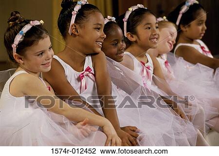 Side profile of a group of ballet dancers sitting together View Large Photo Image Stock Image - Side profile of a group of ballet dancers sitting together. Fotosearch