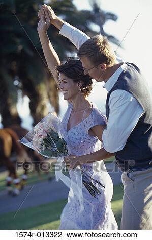 Stock Image - Side profile of a mature couple dancing together. Fotosearch