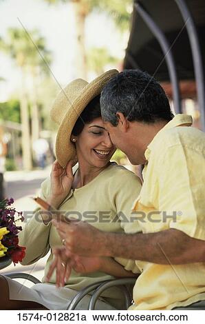 Stock Image - Side profile of a mature couple sitting together. Fotosearch