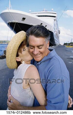 Stock Image - Side profile of a mature couple embracing each other. Fotosearch