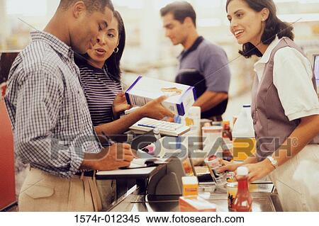 Side profile of a mid adult couple at a checkout counter in a supermarket View Large Photo Image Stock Photography - Side profile of a mid adult couple at a checkout counter in a supermarket. Fotosearch