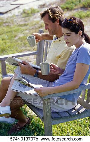 Side profile of a mid adult couple reading the newspaper View Large Photo Image Stock Image - Side profile of a mid adult couple reading the newspaper. Fotosearch