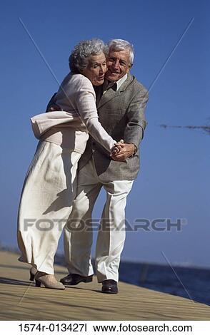 Side profile of a senior couple dancing on a pier View Large Photo Image Stock Image - Side profile of a senior couple dancing on a pier. Fotosearch