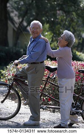 Side profile of a senior couple riding a tandem bicycle View Large Photo Image Stock Image - Side profile of a senior couple riding a tandem bicycle. Fotosearch