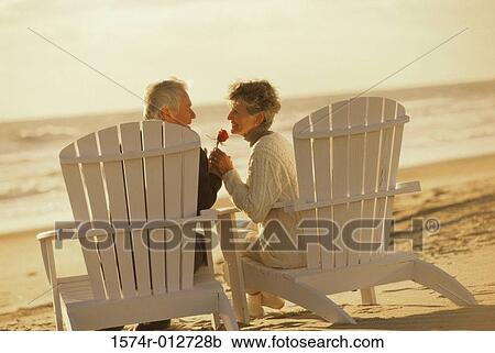 Side profile of a senior couple sitting in chairs View Large Photo Image Stock Image - Side profile of a senior couple sitting in chairs. Fotosearch