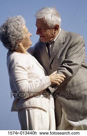 Side profile of a senior couple embracing each other View Large Photo Image Stock Image - Side profile of a senior couple embracing each other. Fotosearch