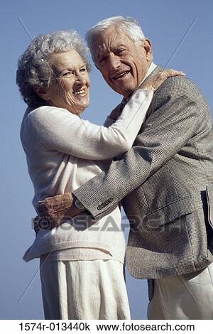 Side profile of a senior couple embracing each other View Large Photo Image Stock Image - Side profile of a senior couple embracing each other. Fotosearch