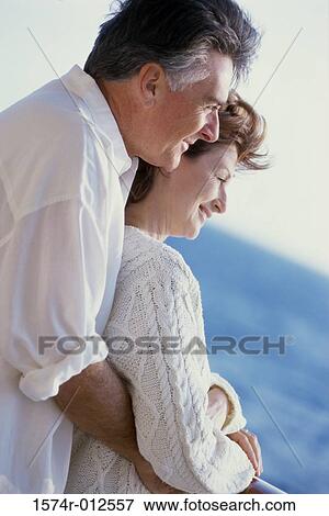 Stock Photo - Side profile of a senior couple embracing. Fotosearch
