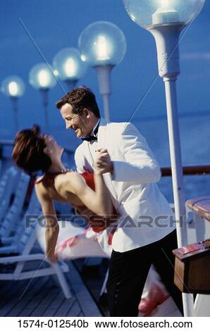 Side profile of a young couple dancing on a cruise ship View Large Photo Image Stock Image - Side profile of a young couple dancing on a cruise ship. Fotosearch