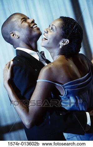Stock Image - Side profile of a young couple dancing. Fotosearch