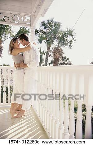 Side profile of a young couple embracing each other View Large Photo Image Stock Image - Side profile of a young couple embracing each other. Fotosearch