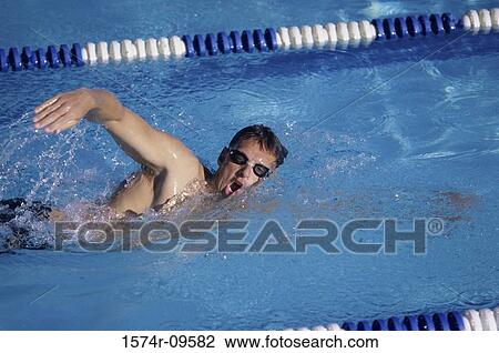 Side profile of a young man swimming in a swimming pool View Large Photo Image Stock Image - Side profile of a young man swimming in a swimming pool. Fotosearch