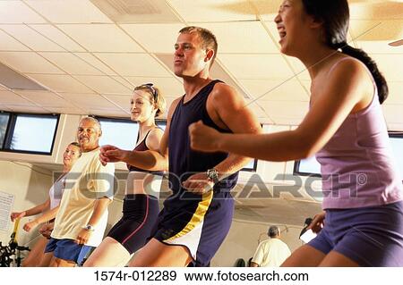 Side profile of five people doing step aerobics in a gym View Large Photo Image Stock Photo - Side profile of five people doing step aerobics in a gym. Fotosearch