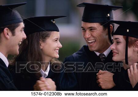 Stock Image - Side profile of four young graduates smiling. Fotosearch
