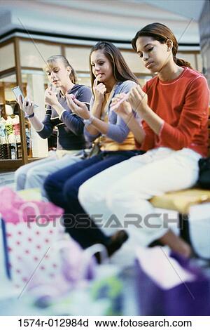 Side profile of three teenage girls grooming themselves View Large Photo Image Stock Image - Side profile of three teenage girls grooming themselves. Fotosearch