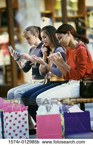 Side profile of three teenage girls grooming themselves View Large Photo Image Stock Image - Side profile of three teenage girls grooming themselves. Fotosearch