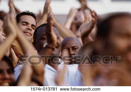 Spectators applauding in a stadium View Large Photo Image Stock Image - Spectators applauding in a stadium. Fotosearch