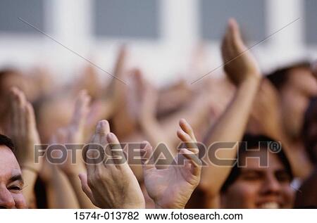 Stock Image - Spectators applauding in a stadium. Fotosearch