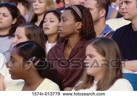 Stock Photo - Spectators sitting in a stadium looking bored. Fotosearch