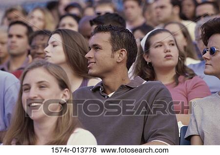 Spectators sitting in a stadium View Large Photo Image Stock Photo - Spectators sitting in a stadium. Fotosearch