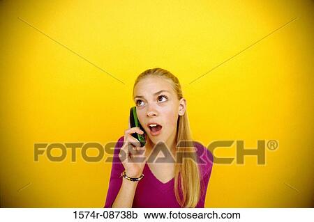Stock Image - Teenage girl talking on a mobile phone. Fotosearch