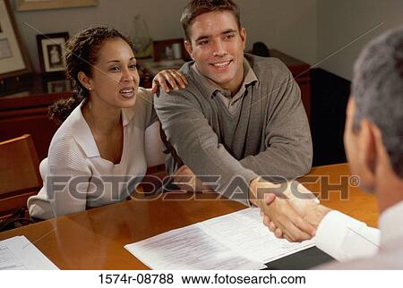 Three business executives shaking hands in a meeting View Large Photo Image Stock Photo - Three business executives shaking hands in a meeting. Fotosearch