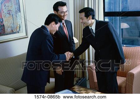 Three businessmen shaking hands View Large Photo Image Stock Image - Three businessmen shaking hands. Fotosearch