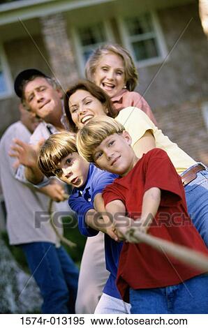 Three generation family playing tug-of-war in the backyard View Large Photo Image Stock Photography - Three generation family playing tug-of-war in the backyard. Fotosearch