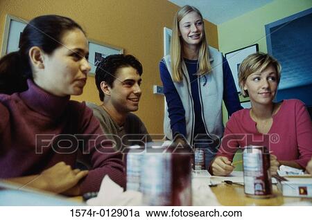 Stock Image - Three teenage girls and a teenage boy in a discussion. Fotosearch