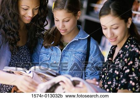 Three teenage girls reading a magazine View Large Photo Image Stock Image - Three teenage girls reading a magazine. Fotosearch
