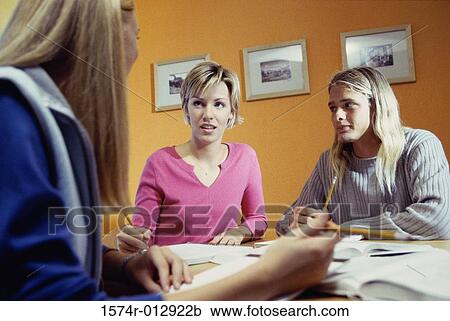 Stock Image - Three teenage girls studying in a room. Fotosearch