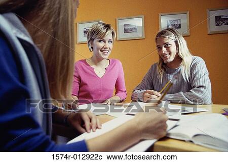 Stock Image - Three teenage girls studying in a room. Fotosearch