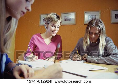 Three teenage girls studying in a room View Large Photo Image Stock Image - Three teenage girls studying in a room. Fotosearch