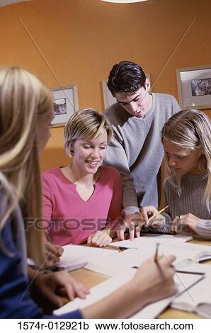 Three teenage girls with a teenage boy studying in a room View Large Photo Image Stock Image - Three teenage girls with a teenage boy studying in a room. Fotosearch