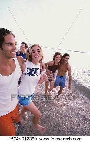 Three young couples on the beach View Large Photo Image Stock Image - Three young couples on the beach. Fotosearch