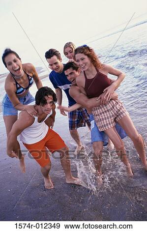 Three young couples on the beach View Large Photo Image Stock Photo - Three young couples on the beach. Fotosearch