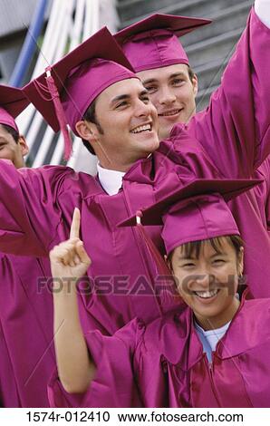 Stock Image - Three young graduates smiling. Fotosearch