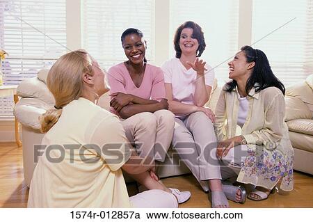 Stock Image - Three young women and a mature woman smiling. Fotosearch
