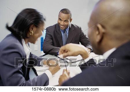 Two businessmen and a businesswoman in a meeting View Large Photo Image Stock Image - Two businessmen and a businesswoman in a meeting. Fotosearch