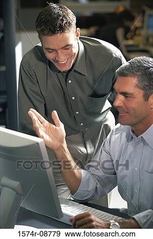 Stock Photo - Two businessmen in an office. Fotosearch