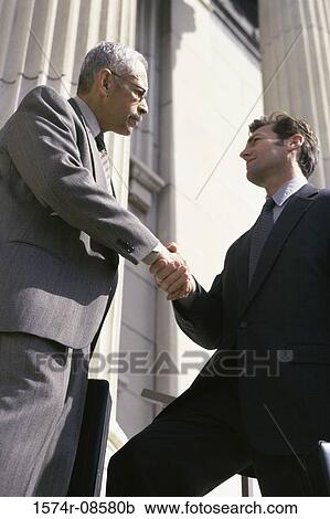 Two businessmen shaking hands View Large Photo Image Stock Image - Two businessmen shaking hands. Fotosearch