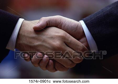 Stock Image - Two businessmen shaking hands. Fotosearch