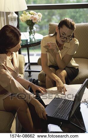 Two businesswomen discussing in an office View Large Photo Image Stock Image - Two businesswomen discussing in an office. Fotosearch