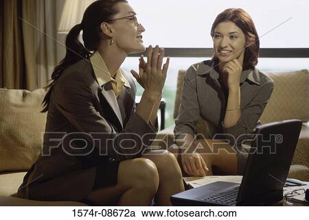 Two businesswomen discussing in an office View Large Photo Image Stock Image - Two businesswomen discussing in an office. Fotosearch