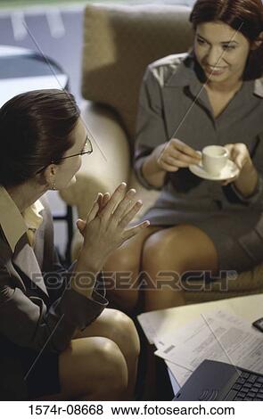 Two businesswomen discussing in an office View Large Photo Image Stock Photo - Two businesswomen discussing in an office. Fotosearch