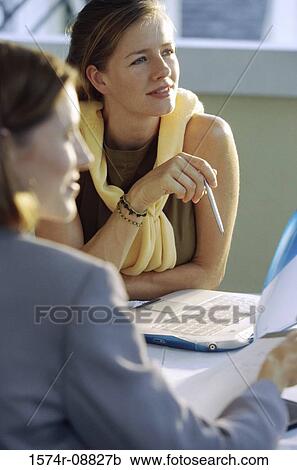 Stock Image - Two businesswomen sitting together. Fotosearch