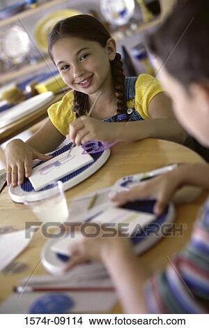 Two children painting with paintbrushes View Large Photo Image Picture - Two children painting with paintbrushes. Fotosearch