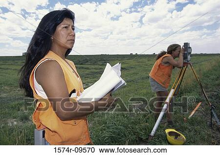 Two female surveyors working View Large Photo Image Stock Image - Two female surveyors working. Fotosearch