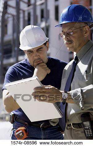 Stock Photograph - Two foremen discussing at a construction site. Fotosearch
